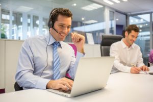 Businessman at office on the phone with headset, Skype